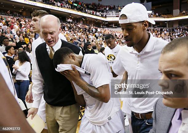 Missouri's Wes Clark leaves the court with Missouri special assistant to the Athletic Director Gary Link, left, and former Missouri star Kim English,...