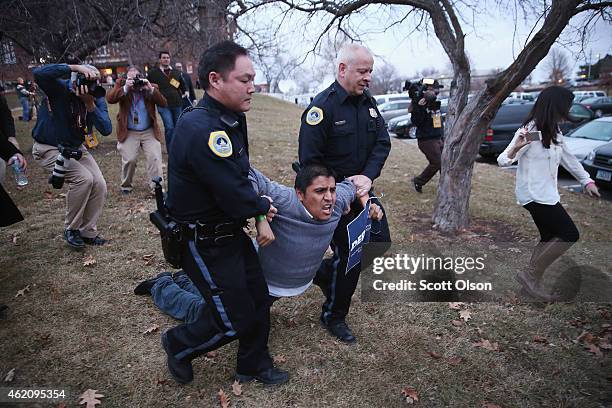 Marco Malagon with the Dream Action Coalition is taken into custody by police after disrupting a speech by former Texas Governor Rick Perry at the...