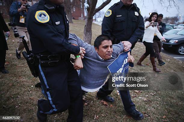 Marco Malagon with the Dream Action Coalition is taken into custody by police after disrupting a speech by former Texas Governor Rick Perry at the...