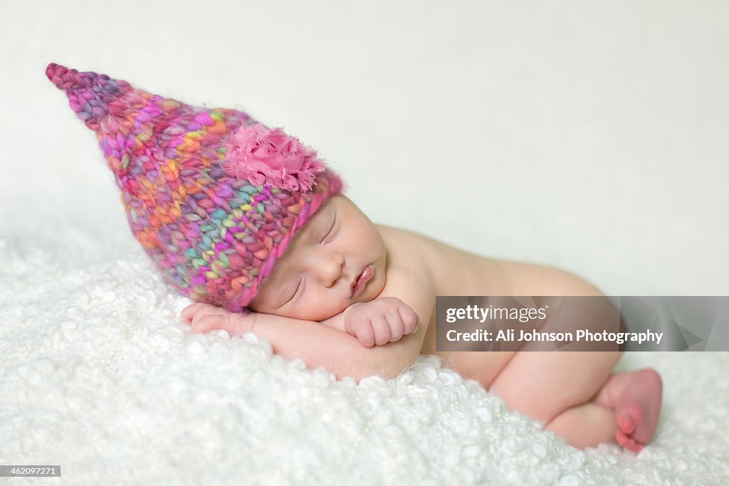 Sleeping baby girl wearing hat