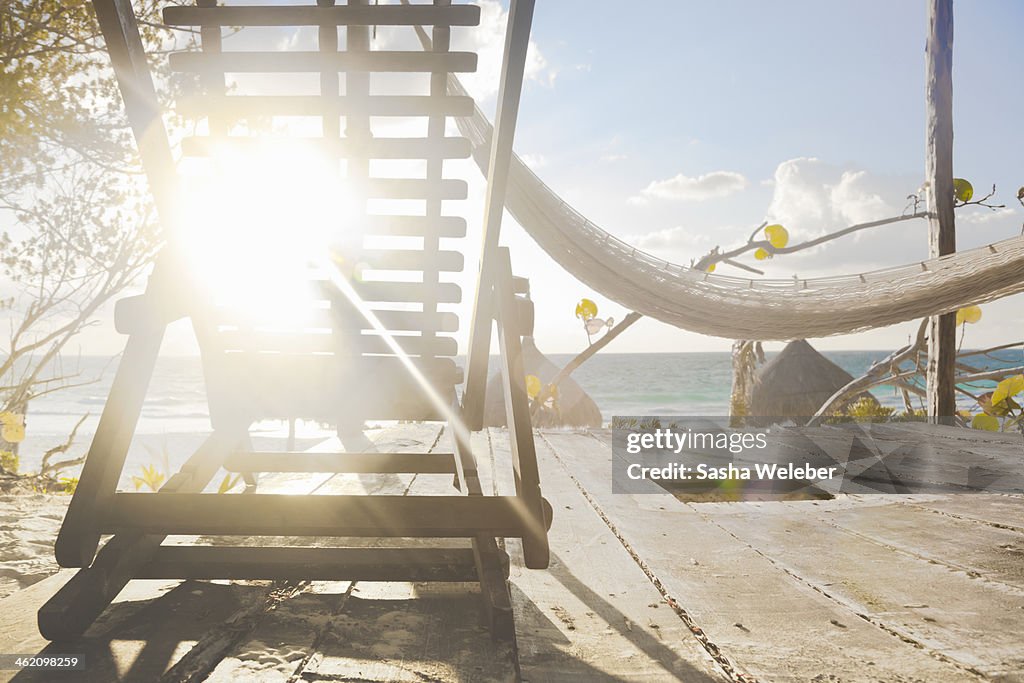 Beach chair and hammock at sunrise on beach