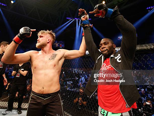 Alexander Gustafsson of Sweden raises opponent Anthony Johnson's hand after Johnson knocked out Gustafsson in their light heavyweight bout during the...