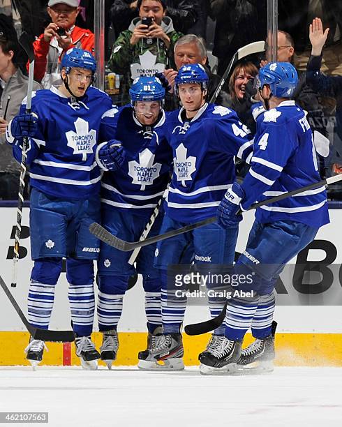 Tyler Bozak of the Toronto Maple Leafs celebrates his first period goal with teammates during NHL game action against the New Jersey Devils January...
