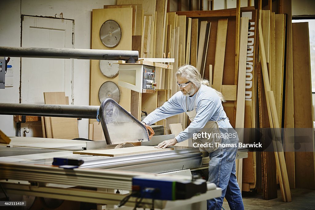 Mature male woodworker working in woodshop