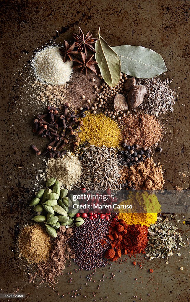 Piles of Various spices on metal surface