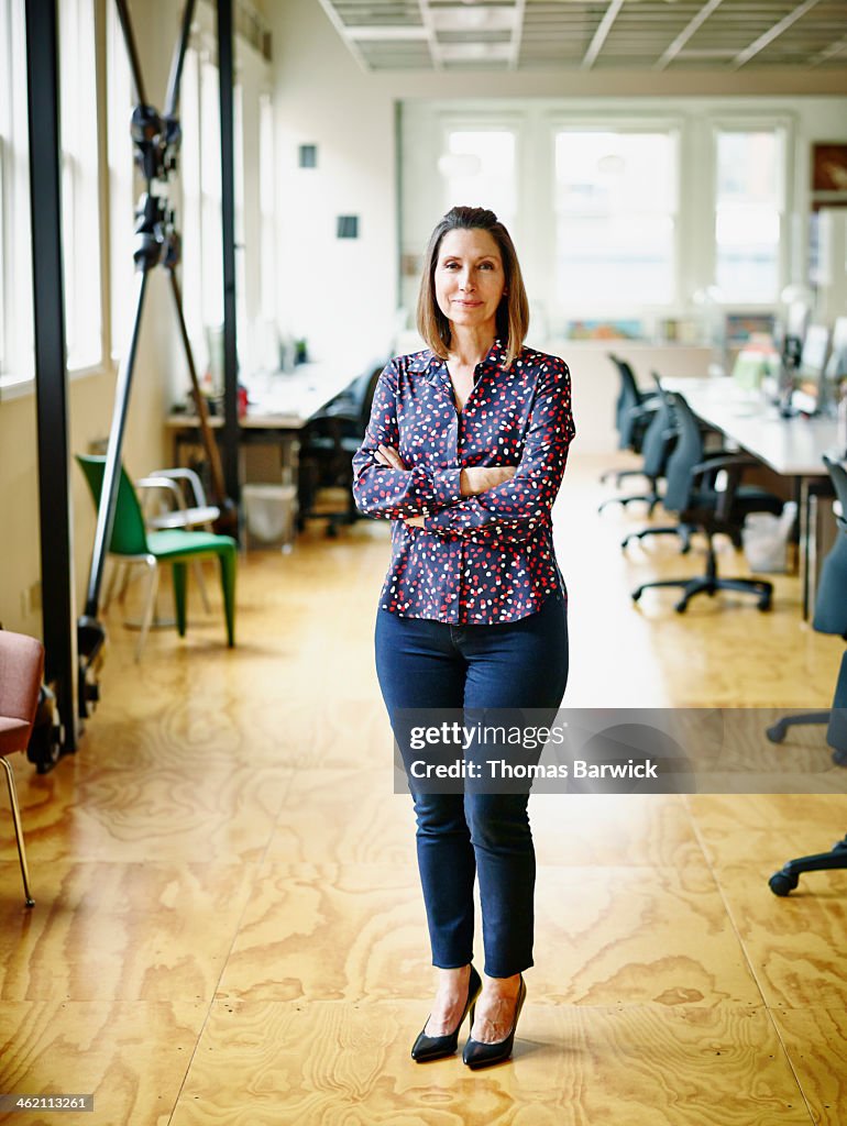 Smiling mature businesswoman in high tech office