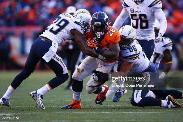 Montee Ball of the Denver Broncos is tackled by Shareece Wright and Jarret Johnson of the San Diego Chargers during the AFC Divisional Playoff Game...