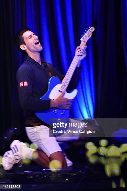 Novak Djokovic plays guitar at the ANZ Jam Slam on Grand Slam Oval with a hologram of Aussie music star Keith Urban during the 2015 Australian Open...