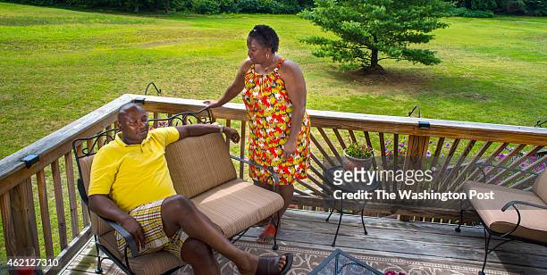 Denise Watson and her husband Samuel Kargbo on their back deck which, has a view of the 11th fairway of the neighborhood golf course behind their...