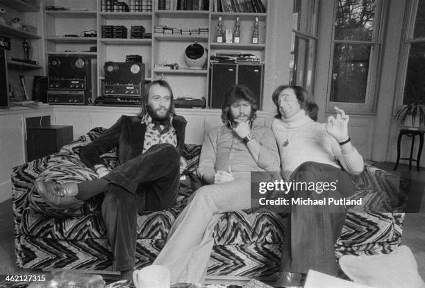 Pop vocal trio The Bee Gees, Windsor, Berkshire, February 1974. Left to right: Maurice Gibb , Barry Gibb and Robin Gibb .