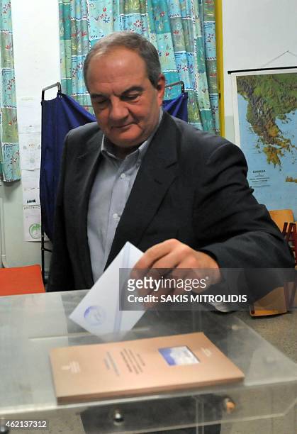 Former prime minister Kostas Karamanlis casts his vote during the general elections at a polling station in the northern port city of Thessaloniki,...