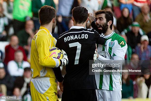 Cristiano Ronaldo of Real Madrid CF reacts next to Jose Angel Crespo of Cordoba CF beside his teammate, goalkeeper Juan Carlos Martin , shortly...