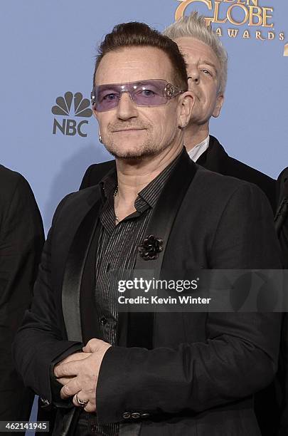 Musician Bono of U2, winner of Best Original Song for 'Ordinary Love' from 'Mandela: Long Walk to Freedom,' poses in the press room during the 71st...