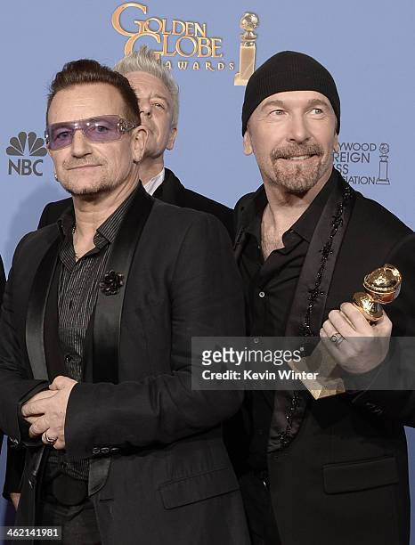 Musicians Bono and The Edge of U2, winners of Best Original Song for 'Ordinary Love' from 'Mandela: Long Walk to Freedom,' pose in the press room...