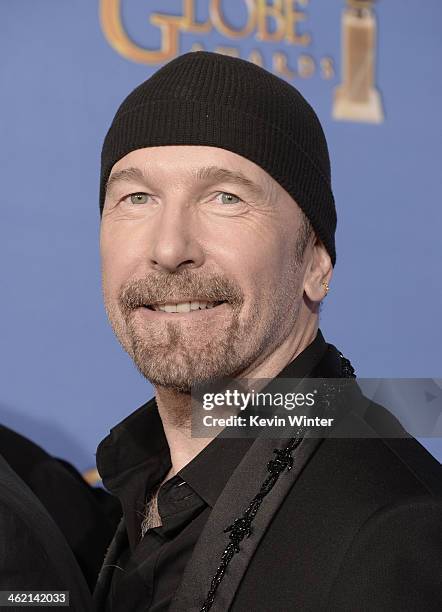 Musician The Edge of U2, winner of Best Original Song for 'Ordinary Love' from 'Mandela: Long Walk to Freedom,' poses in the press room during the...