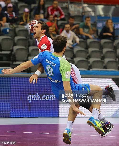 Macedonia's Filip Mirkulovski attempts a shot on goal over Slovenia's Jure Natek during the 24th Men's Handball World Championships Eighth Final EF1...