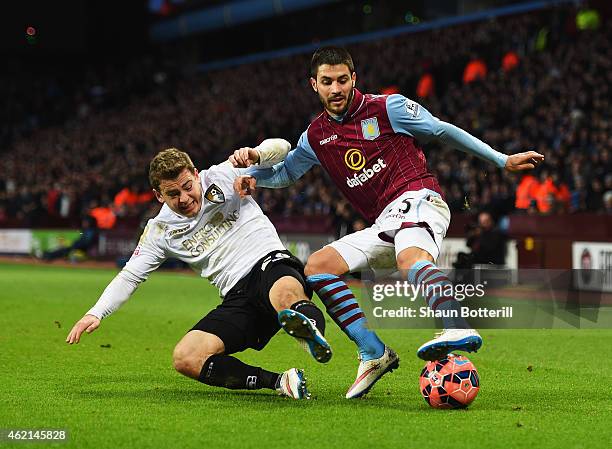 Carles Gil of Aston Villa is tackled by Ryan Fraser of Bournemouth during the FA Cup Fourth Round match between Aston Villa and AFC Bournemouth at...