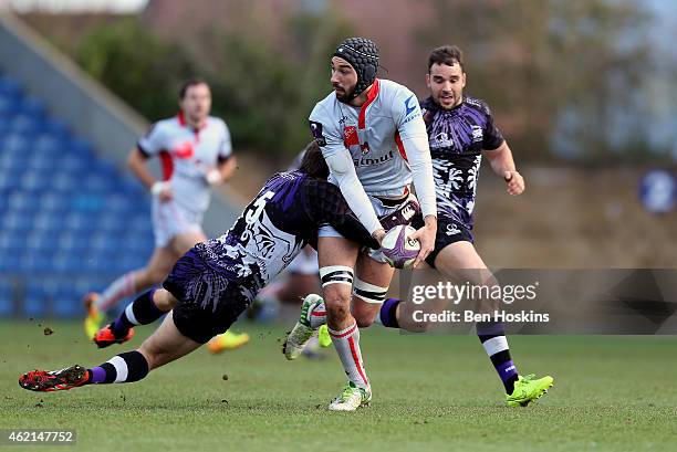 Steevy Cerqueira of Lyon looks to offload under pressure from Matt Corker of London Welsh during the European Rugby Challenge Cup match between...
