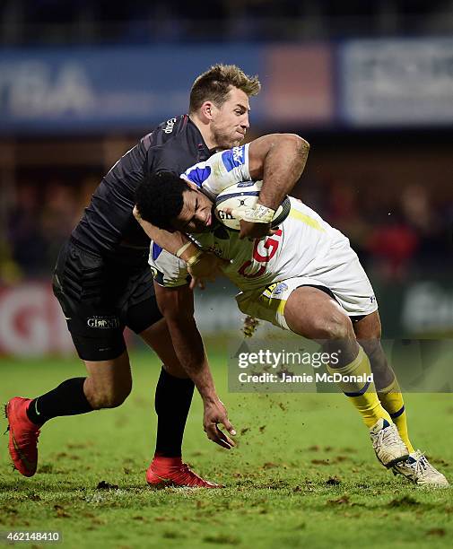 Naipolioni Nalaga of Clermont is tackled by Chris Wyles of Saracens during the European Rugby Champions Cup Pool 1 match between Clermont Auvergne...