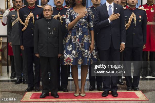 Indian President Pranab Mukherjee stands for the American National Anthem alongside US President Barack Obama and First Lady Michelle Obama prior to...