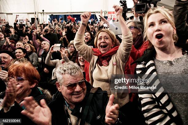 Supporters of the opposition radical leftist Syriza party cheer at exit poll results which indicate that Syriza have a clear lead on January 25, 2015...