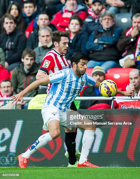Ibia Gomez of Athletic Club duels for the ball withÊMiguel Torres of Malaga CF during the La Liga match between Athletic Club and Malaga CF at San...