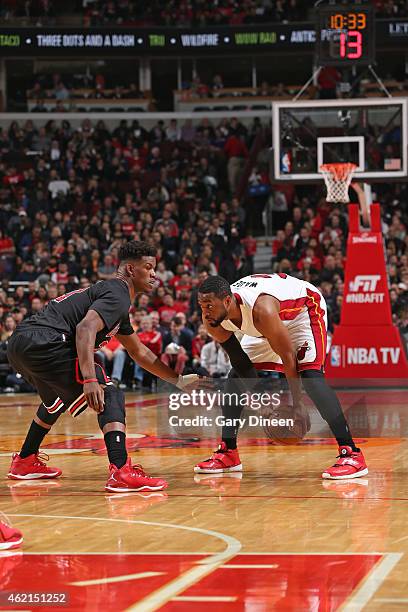 Dwyane Wade of the Miami Heat handles the ball against Jimmy Butler of the Chicago Bulls during the game on January 25, 2015 at the United Center in...