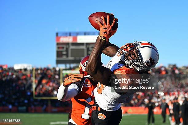 Sammie Coates of the South team catches a pass in front of Josh Shaw of the North team during the Reese's Senior Bowl at Ladd Peebles Stadium on...