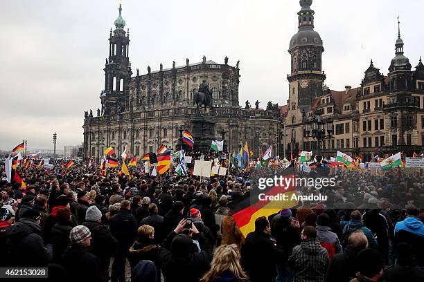 Supporters of the Pegida movement stage protest with banners and German flags at the Theaterplatz Square in Dresden, Germany on January 25, 2015.