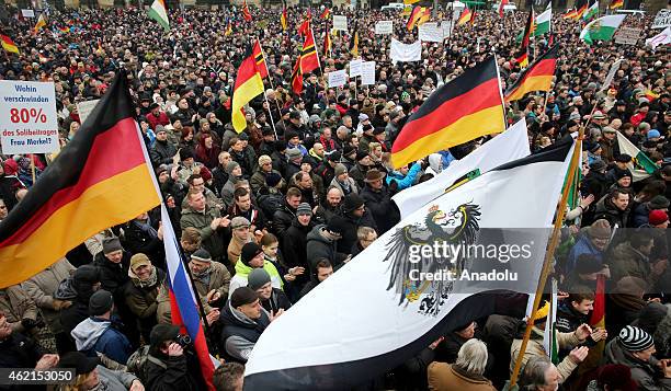 Supporters of the Pegida movement stage protest with banners and German flags at the Theaterplatz Square in Dresden, Germany on January 25, 2015.