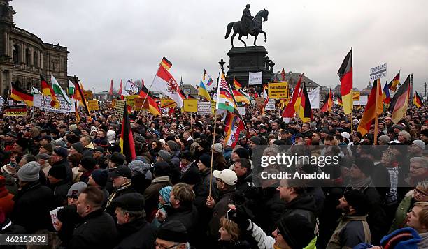 Supporters of the Pegida movement stage protest with banners and German flags at the Theaterplatz Square in Dresden, Germany on January 25, 2015.