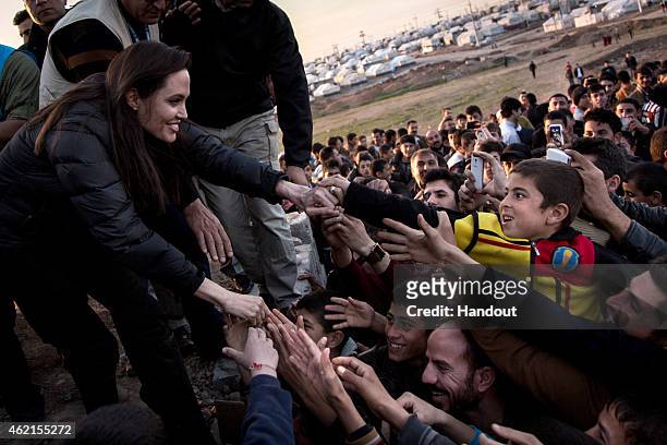 In this handout image provided by UNHCR, UNHCR Special Envoy Angelina Jolie meets members of the Yazidi minority in Khanke IDP Camp on January 25,...