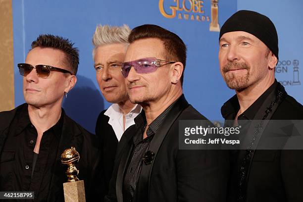 Musicians Larry Mullen Jr., Adam Clayton, Bono and The Edge of U2 pose in the press room during the 71st Annual Golden Globe Awards held at The...