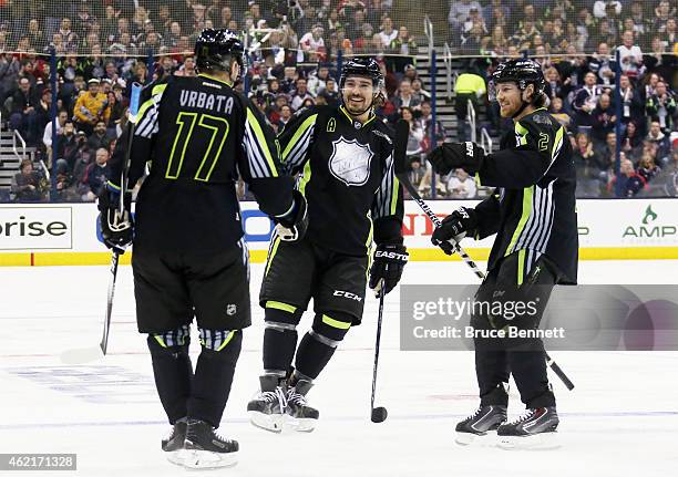 Radim Vrbata of the Vancouver Canucks and Team Foligno celebrates with Drew Doughty of the Los Angeles Kings after scoring a goal in the first period...