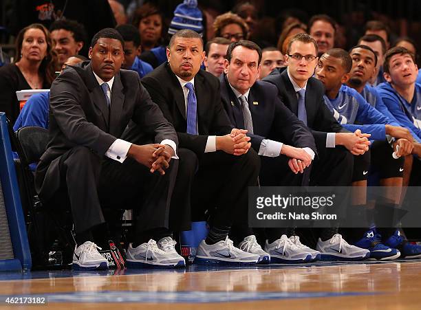Assistant Coach Nate James, Associate Head Coach Jeff Capel, Head Coach Mike Krzyzewski and Assistant Coach Jon Scheyer look on as they sit on the...