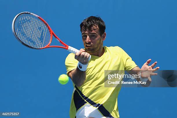 Ivan Dodig of Croatia plays a forehand in his first round match against Ivo Karlovic of Croatia during day one of the 2014 Australian Open at...