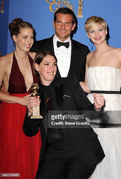 Actress Amy Adams, producer Megan Ellison, actor Bradley Cooper and actress Jennifer Lawrence pose in the press room during the 71st Annual Golden...
