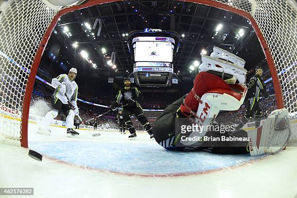 Patrik Elias of the New Jersey Devils and Team Toews and Brent Burns of the San Jose Sharks and Team Foligno watch the puck go into the net on a goal...