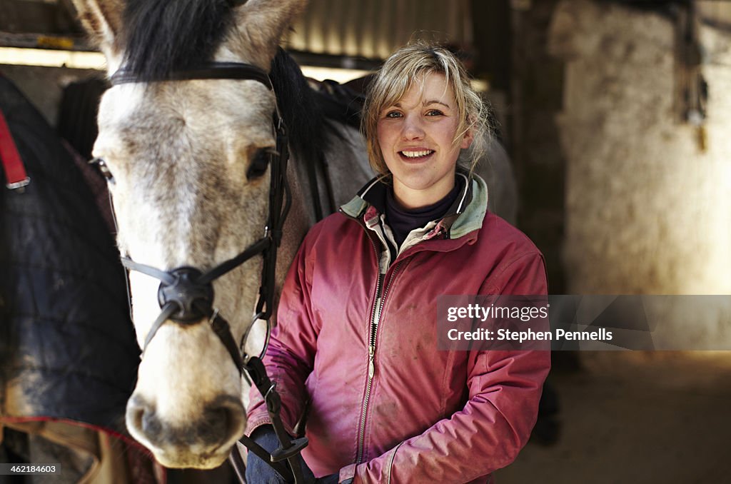 Horse and owner in stables