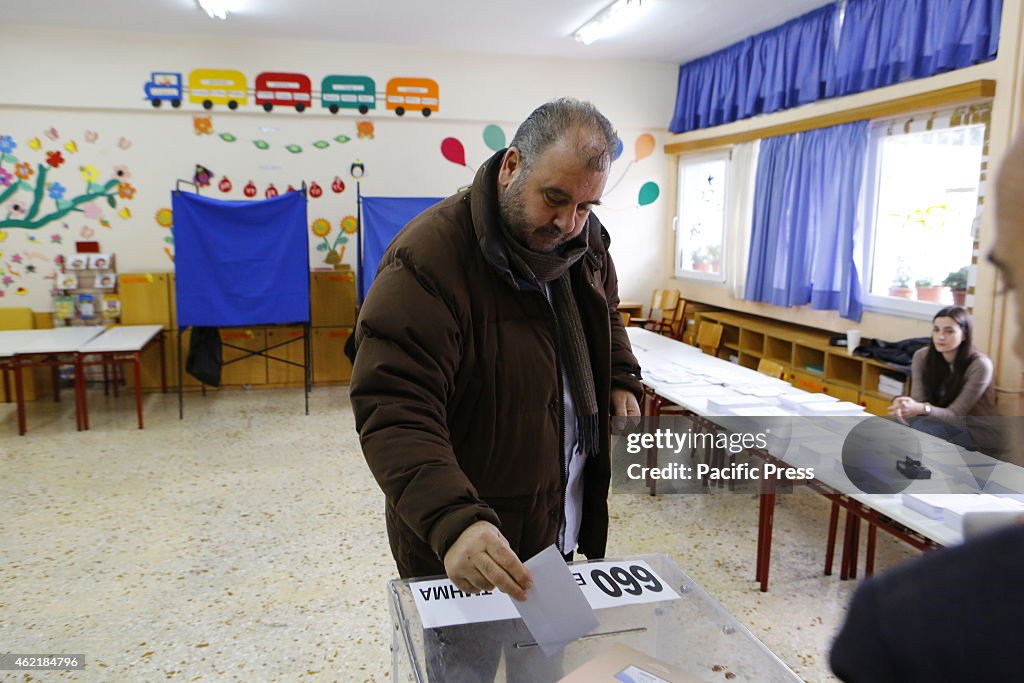 A voter casts his vote into the voting urn. Less then a...