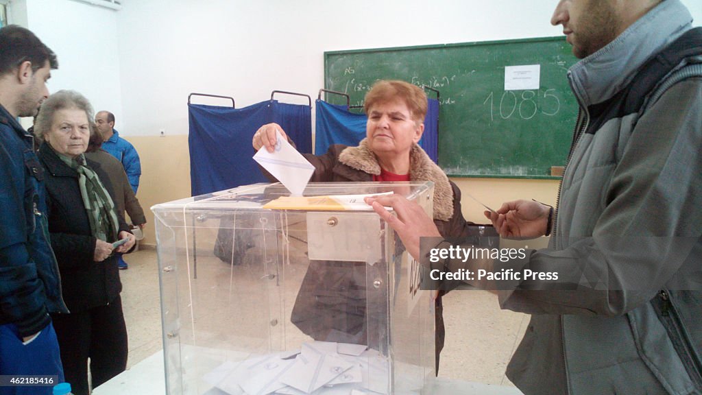 A woman casts her vote.People all over Greece vote for the...