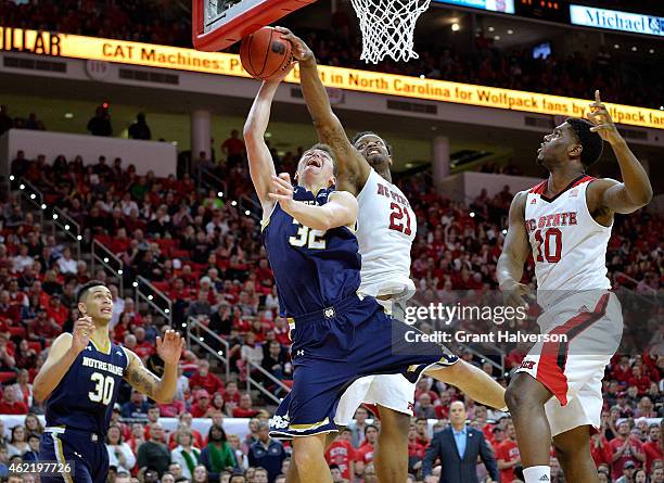 Beejay Anya of the North Carolina State Wolfpack blocks a shot by Steve Vasturia of the Notre Dame Fighting Irish during their game at PNC Arena on...