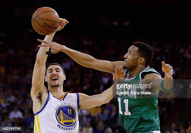 Klay Thompson of the Golden State Warriors has a shot blocked by Evan Turner of the Boston Celtics at ORACLE Arena on January 25, 2015 in Oakland,...