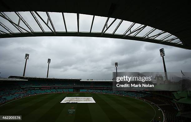 Rain forces the SCG ground staff to leave the covers on before the One Day International match between Australia and India at Sydney Cricket Ground...