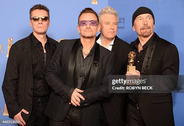 Musicians Larry Mullen Jr., Bono, Adam Clayton and The Edge of U2 celebrate winning Best Original Song for "Ordinary Love" from "Mandela: Long Walk...