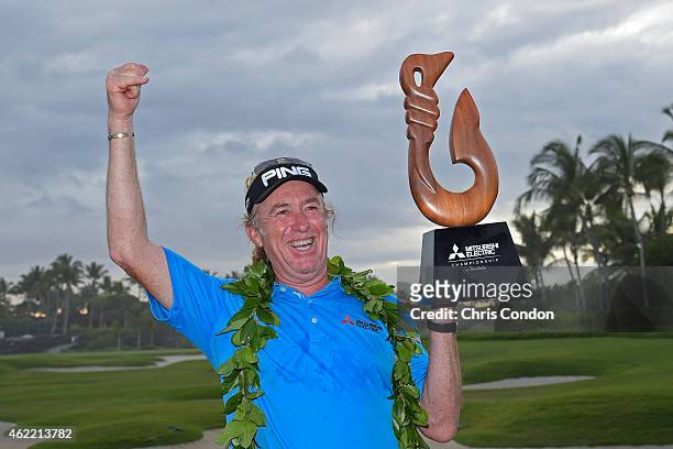 Miguel Angel Jimenez poses with the tournament trophy after winning the Champions Tour Mitsubishi Electric Championship at Hualalai Golf Club on...