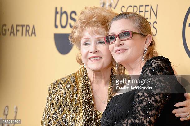 Actresses Debbie Reynolds and Carrie Fisher pose in the press room at the 21st Annual Screen Actors Guild Awards at The Shrine Auditorium on January...