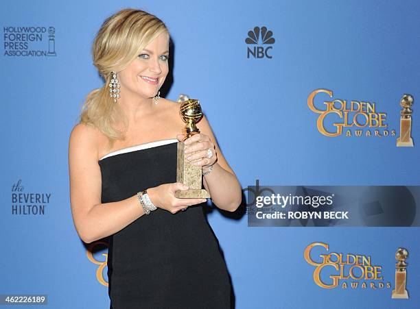 Actress Amy Poehler celebrates winning Best Actress in a Television Series - Musical or Comedy for "Parks and Recreation" in the press room during...