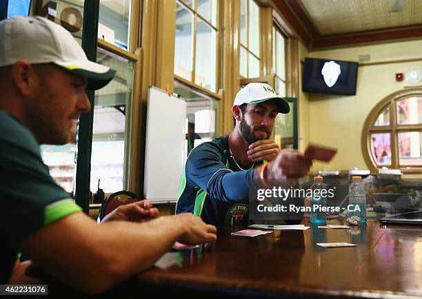 Glenn Maxwell and Aaron Finch of Australia play cards in the change rooms during a rain delay during the One Day International match between...