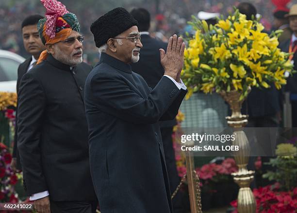 Indian Vice President Mohammad Hamid Ansari gestures as he arrives alongside Indian Prime Minister Narendra Modi as they attend the country's...